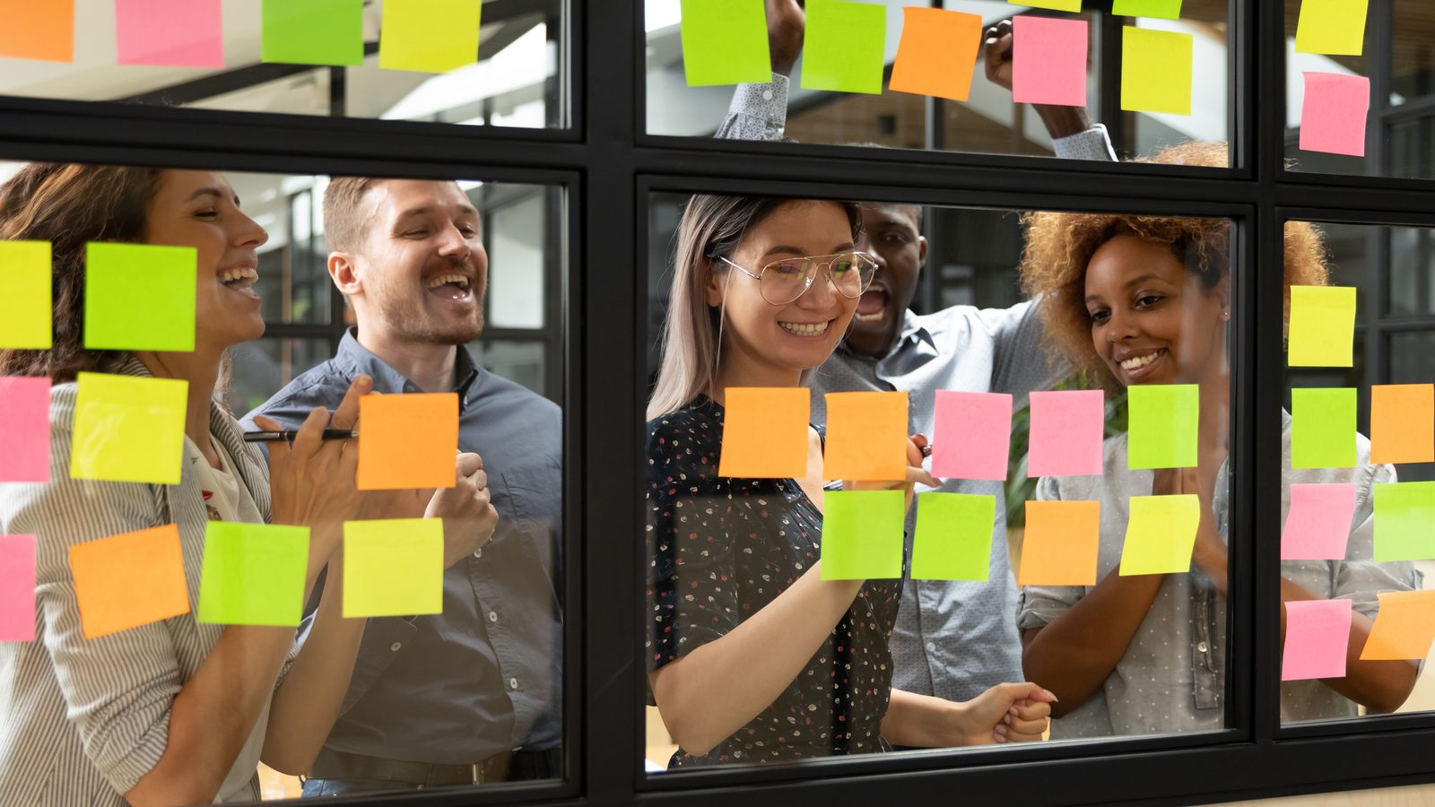 A team collaborating with sticky notes, echoing the Flourishing Teams card exercise